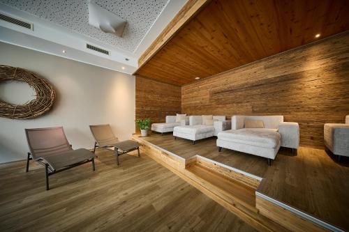 a living room with white couches and chairs at Leni-Marie Saalbach in Saalbach-Hinterglemm