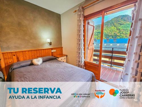 a bedroom with a bed and a large window at Hotel Casa Morlans 3000 in Panticosa