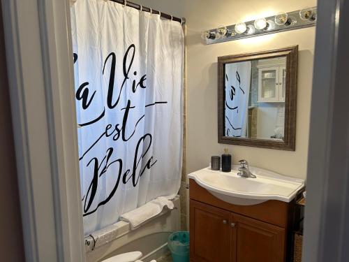 a bathroom with a shower curtain that says a life best ride at Lakeview in Colborne