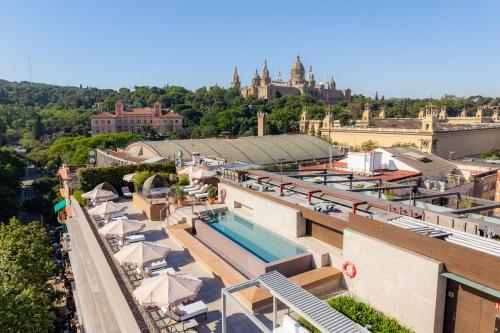 a hotel with a swimming pool on top of a building at InterContinental Barcelona by IHG in Barcelona
