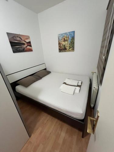 a small bed in a small room with a phone at STUDIOAPARTMANI JEDVAJ in Krapina