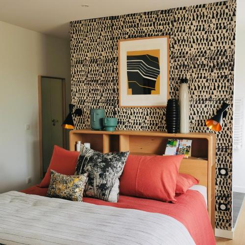 a bedroom with a bed and a patterned wall at VILLA FIGUE BLANCHE in Montagny-lès-Buxy
