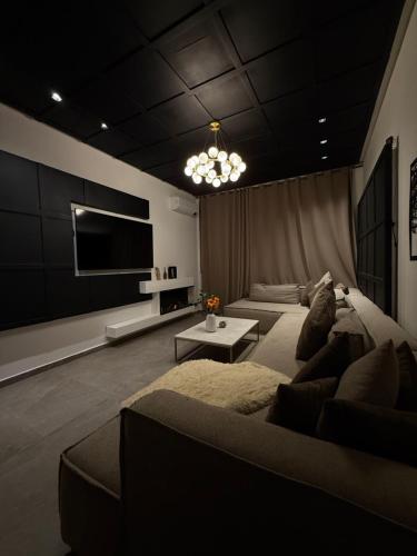 a living room with a couch and a flat screen tv at Penthouse Meknes in Meknès