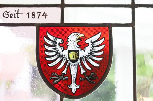 a stained glass window with a red shield at Hotel-Restaurant Arneggers Adler in Tiefenbronn