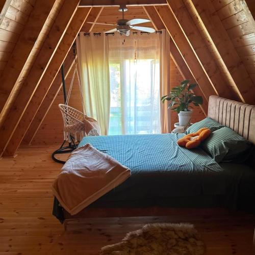 a bedroom with a bed and a window in a attic at Careva staza in Nikšić
