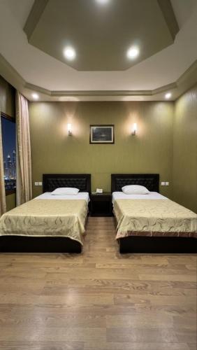 two beds sitting in a room with at Zarina Hotels & Hamam in Batumi