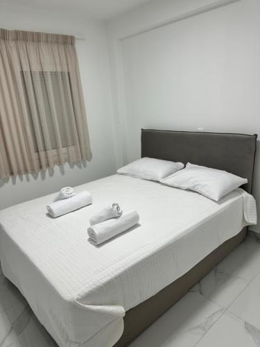 a bed with two towels on top of it at Nōema Residences II in Nafpaktos