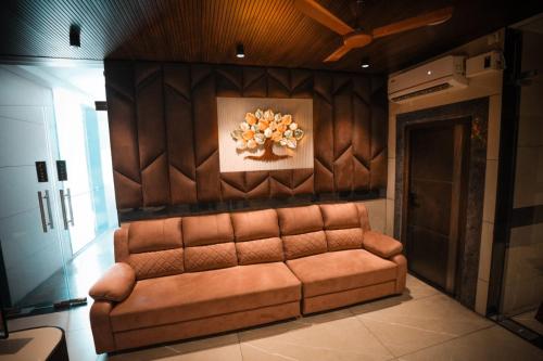 a couch in a room with a painting on the wall at KAR Towers in Ārani