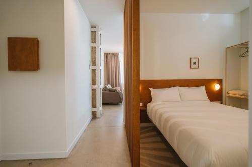 a bedroom with a large bed in a room at Apartamentos Turísticos - ELBUZONROJO in Burgos