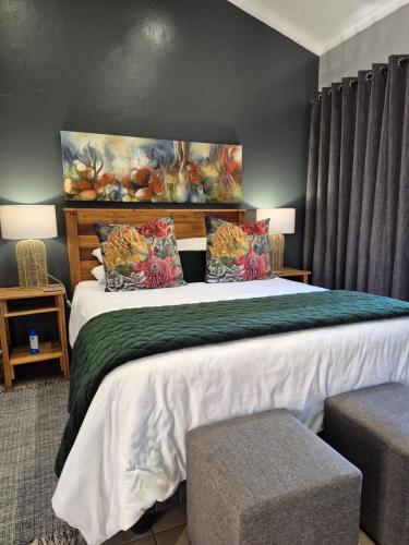 a bedroom with a large bed with two pillows at Bendor Garden Flat in Polokwane