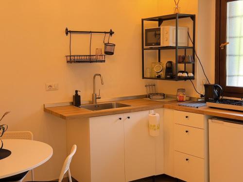 a small kitchen with a sink and a table at Cozy House in Corte in Vimodrone