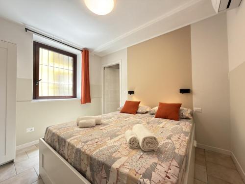 a bedroom with a large bed and a window at Cozy House in Corte in Vimodrone