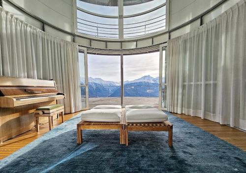 a bedroom with a bed and a grand piano at Turm Chalet in Laces