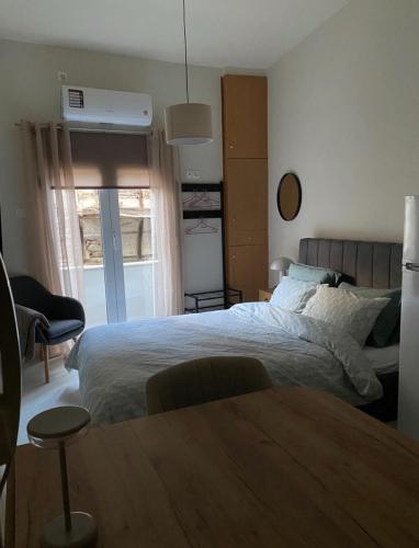 a bedroom with a bed and a table in it at Jasmine Studio 3 Pigadia Siatista in Siátista