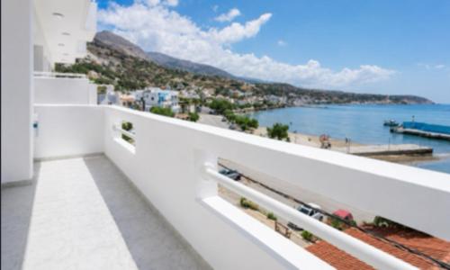 a balcony with a view of a beach and the ocean at Triton Sea View Studios in Tsoutsouros