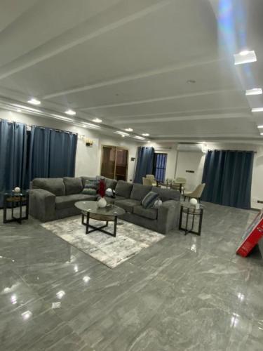 a large living room with couches and a table at AMINA luxury SUITE in Lomé