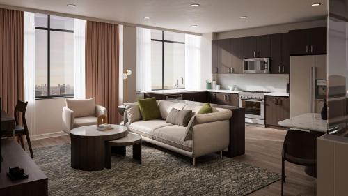 ein Wohnzimmer mit Sofa und eine Küche in der Unterkunft Vintedge Residences in Lyndhurst