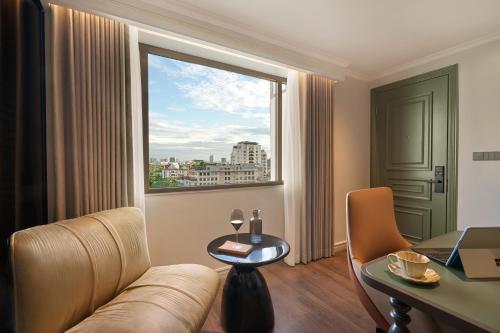 a living room with a couch and a table and a window at Solaria d'Oriente Hotel in Hanoi