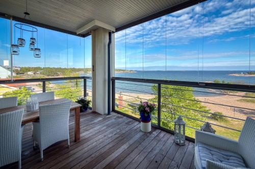 a balcony with a table and chairs and a view of the ocean at Panorama Suite in Hanko in Hanko