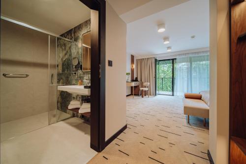 a bathroom with a shower and a sink at Mariental Hotel & SPA in Szklarska Poręba