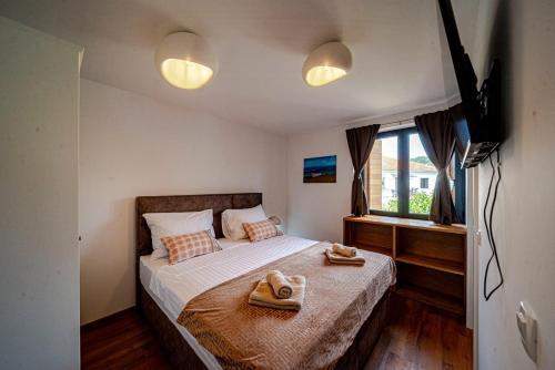 a bedroom with a bed with towels on it at Villa Plitvina in Vela Luka