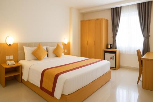 a bedroom with a large bed and a window at Son Mi Hotel in Ho Chi Minh City