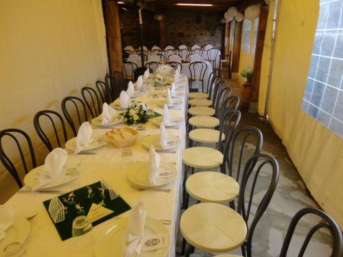 a long table set up for a banquet with chairs at Casale l'Antico Carro in Cortona