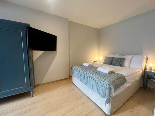 a bedroom with a bed and a flat screen tv at Hotel Eden Palace au Lac in Montreux