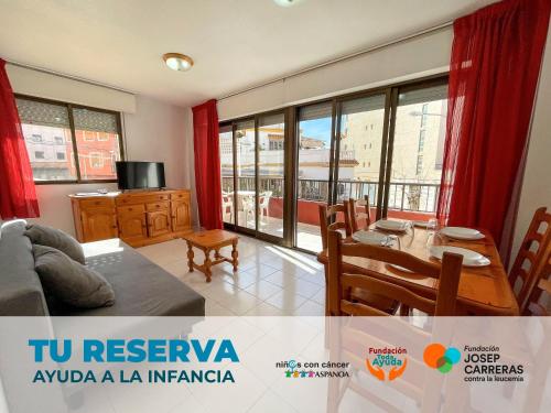 a living room with a couch and a table at Apartamentos Playa Oropesa 3000 in Oropesa del Mar