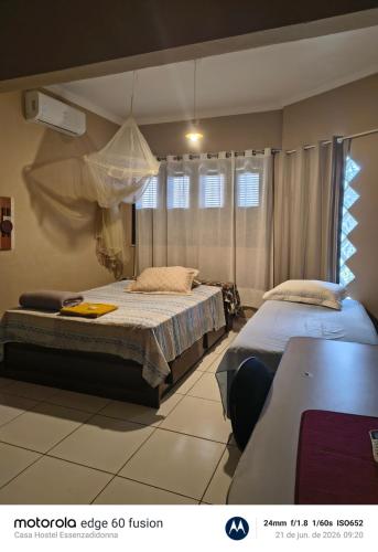 a bedroom with two beds and a window at Casa Hostel Essenza di Donna in São Luís