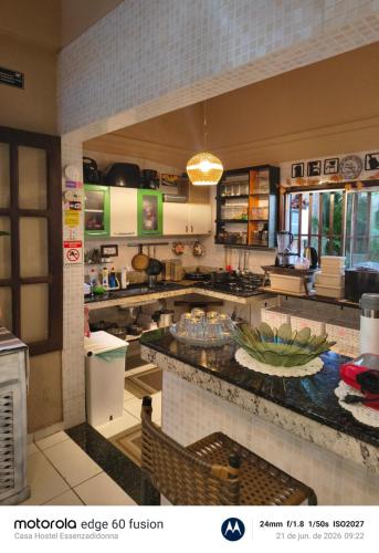 a large kitchen with a counter in a room at Casa Hostel Essenza di Donna in São Luís