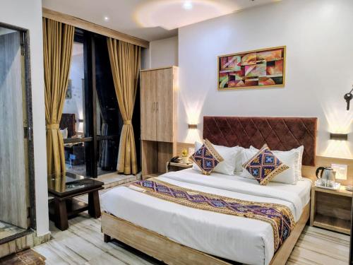a bedroom with a large bed in a room at Hotel Annex International Near International Airport in Mumbai