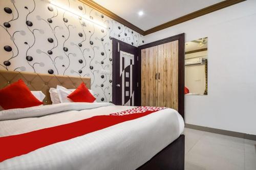a bedroom with a large bed with red pillows at Hotel Amrapali UDAIPUR BEST GORUP BOOKING HOTEL NEAR CA CIRCLE in Udaipur