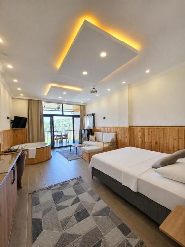 a bedroom with a large bed and a living room at Aurora Suit Bungalov in Rize