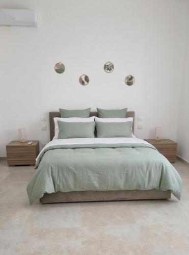 a white bedroom with a bed and two night stands at Appartamenti Del Pesco in Trapani