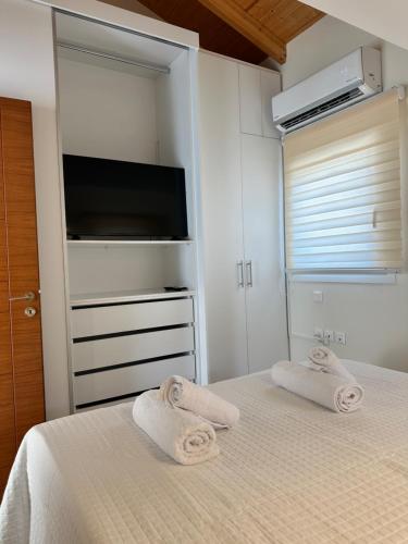 a bedroom with a bed with towels on it at Nōema Residences I in Nafpaktos