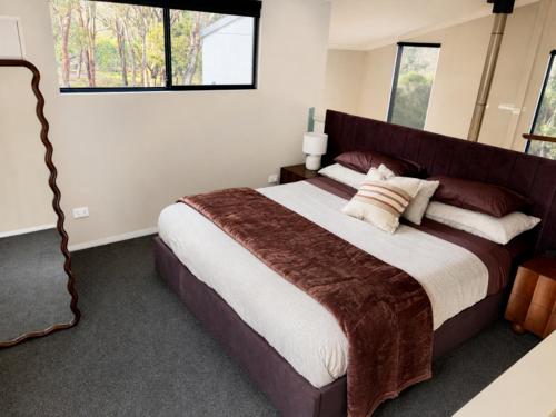 a bedroom with a large bed and a window at Kalamata - Adults Only Country Escape in Boyup Brook