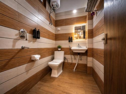a bathroom with a toilet and a sink at Signature StayZ - Amar Singh Palace Near Taj Mahal in Agra
