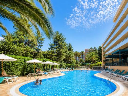 a pool at a resort with people in it at Aparthotel SunClub Salou in Salou