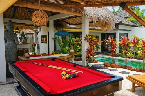 a pool table in front of a villa at Hakuna Matata Bali Villas in Uluwatu
