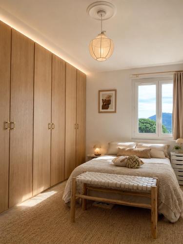 a bedroom with a large bed and a window at Villa Boho Cassis in Cassis