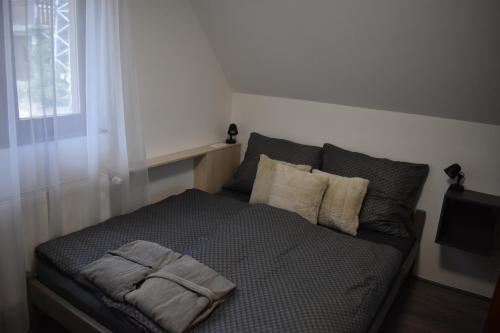 a bedroom with a bed with a towel on it at Aranyos Downhill in Nagymaros