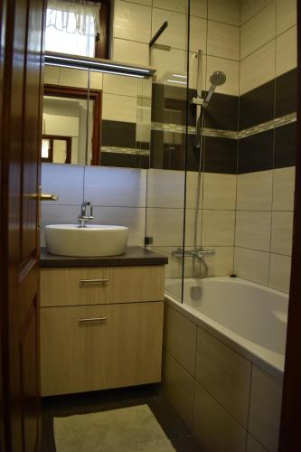 a bathroom with a sink and a bath tub at Aranyos Downhill in Nagymaros
