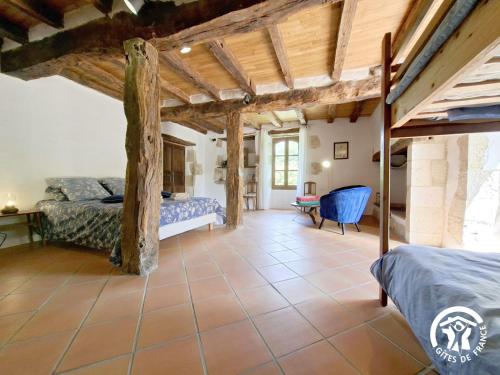 a bedroom in a house with two beds at Brasserie du Goutté in Roquefort