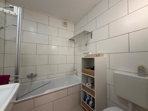 a bathroom with a tub and a toilet and a sink at Casa Constantinus in Unteruhldingen