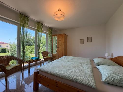a bedroom with a bed and a large window at Casa Constantinus in Unteruhldingen