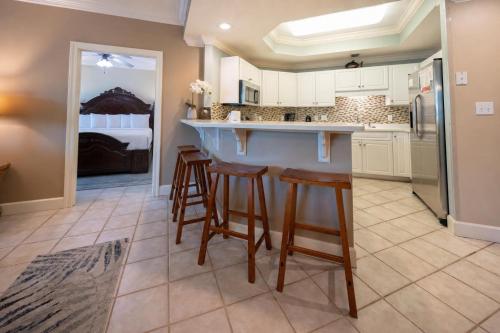 a kitchen with a bar with stools and a bed at Phoenix on the Bay 1324 in Orange Beach