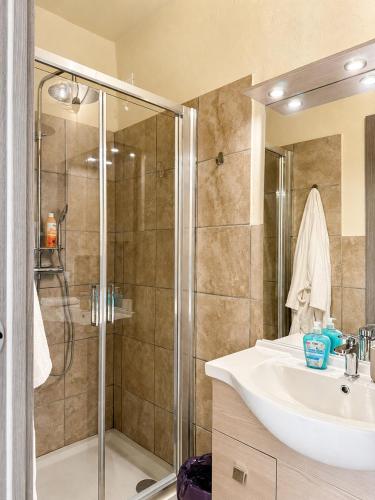 a bathroom with a sink and a shower at BaB Apartments Tavernola in Tavernola Bergamasca