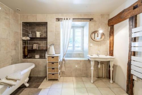 a bathroom with a tub and a sink at Sarahandia in Aldudes
