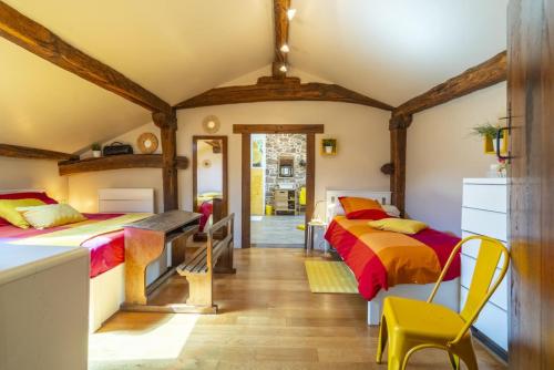two beds in a room with wooden ceilings at Sarahandia in Aldudes